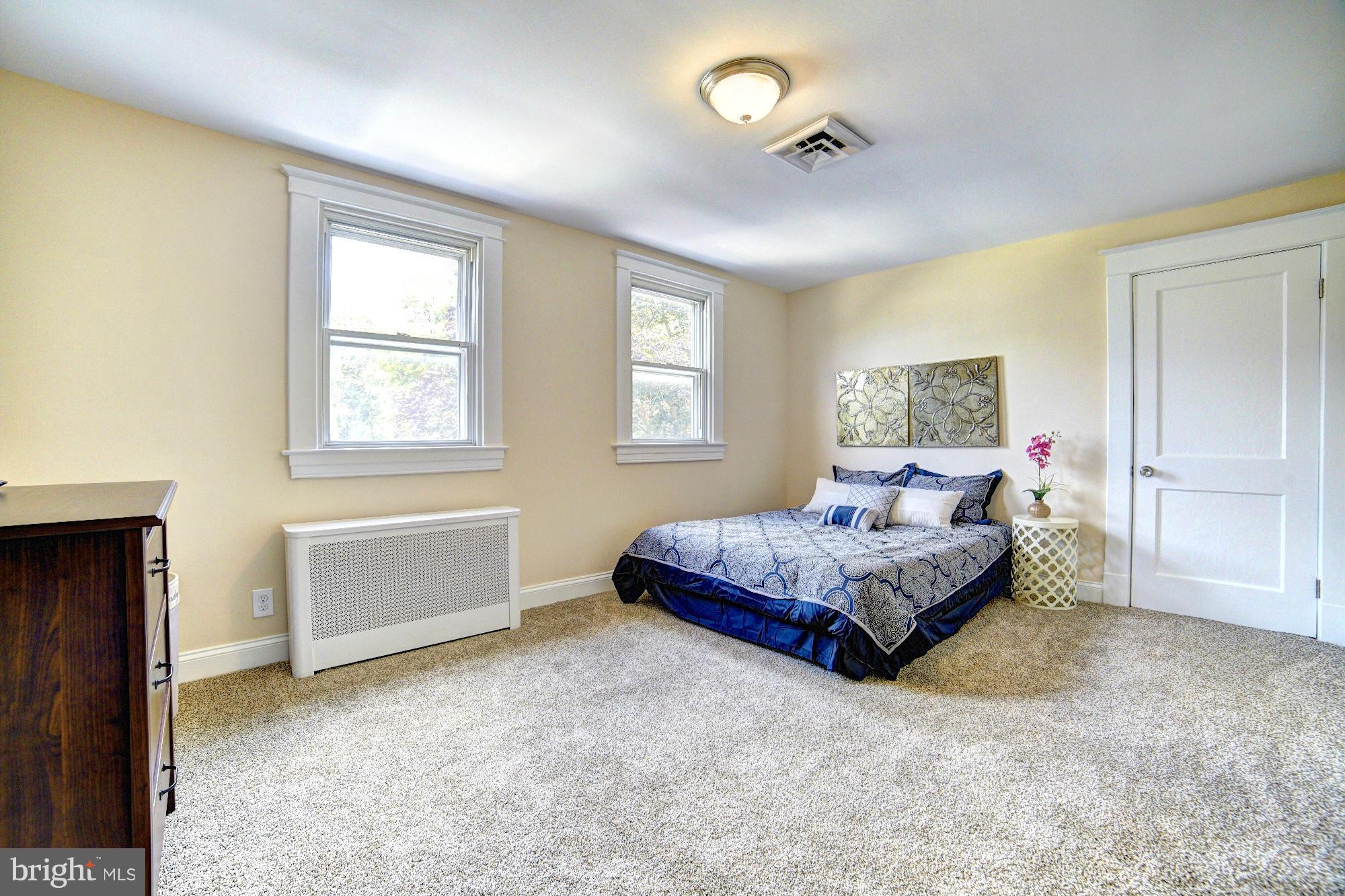 5408 Catalpha Road Baltimore, MD 21214 - Photo 14 of 23 a spacious bedroom with a bed and window