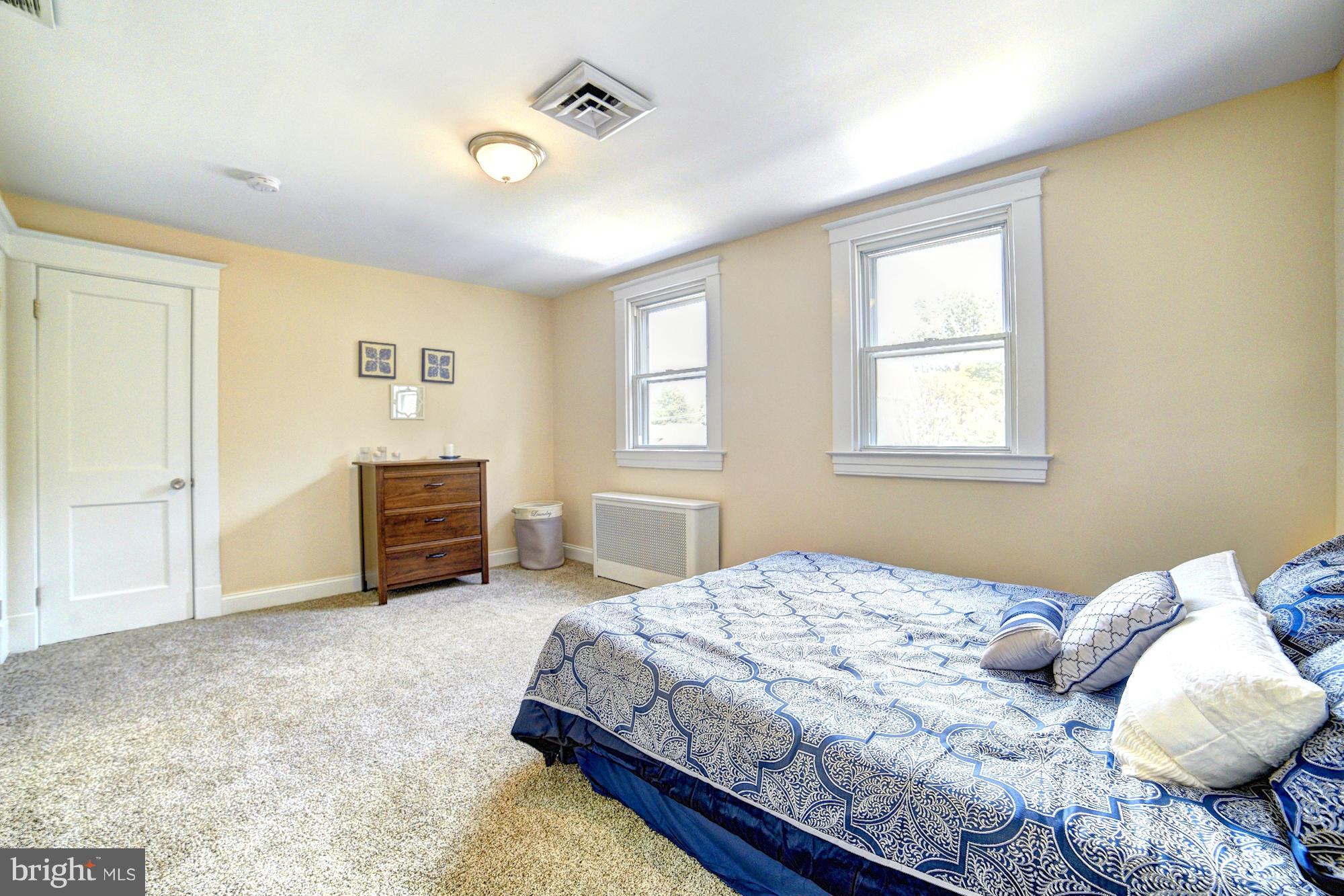 5408 Catalpha Road Baltimore, MD 21214 - Photo 15 of 23 a bedroom with a bed next to a window and a dresser