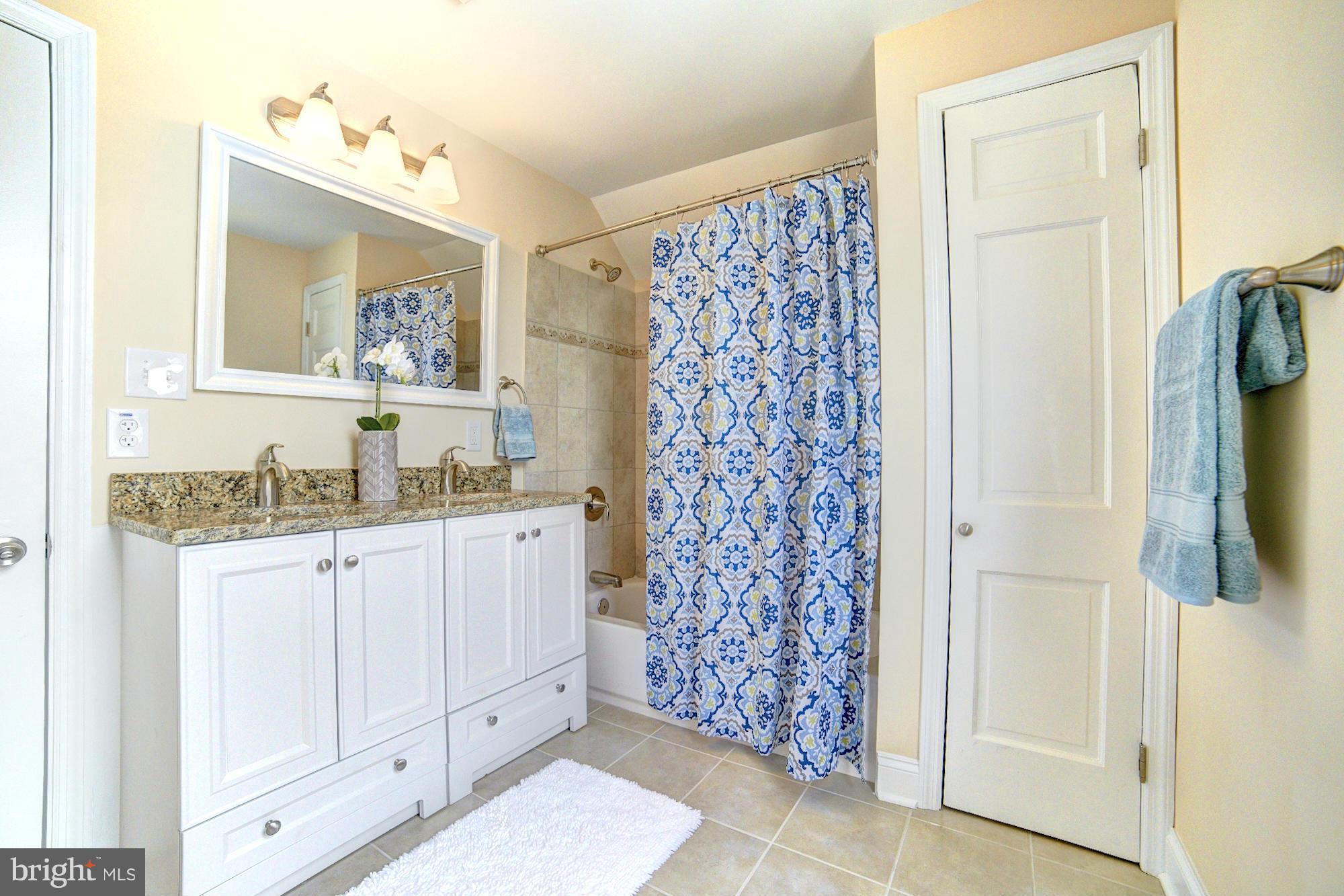 5408 Catalpha Road Baltimore, MD 21214 - Photo 17 of 23 a bathroom with a granite countertop sink and a mirror