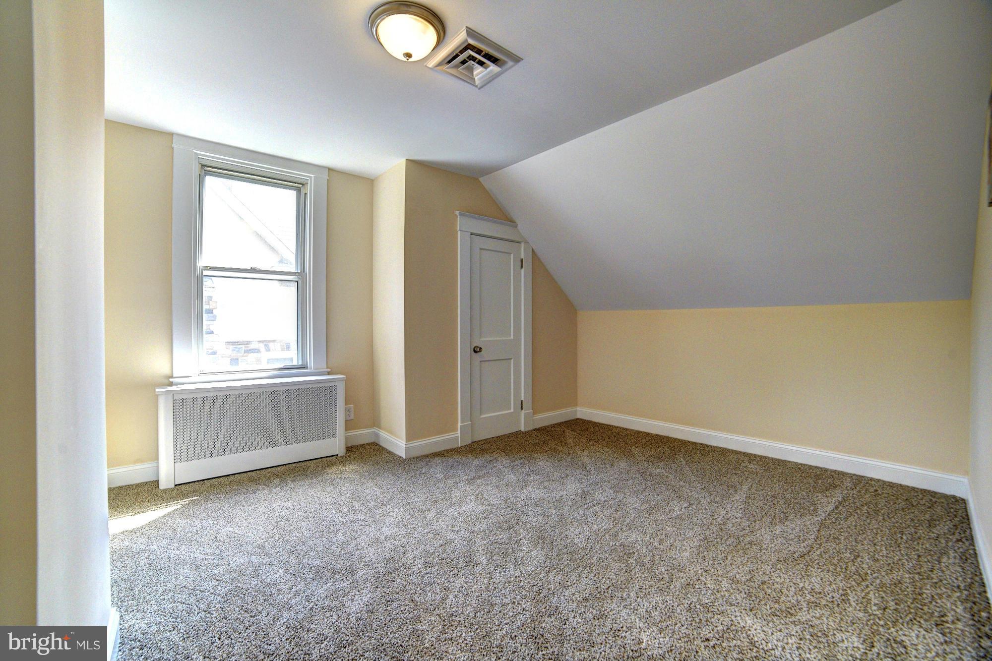 5408 Catalpha Road Baltimore, MD 21214 - Photo 18 of 23 a view of an empty room with a window