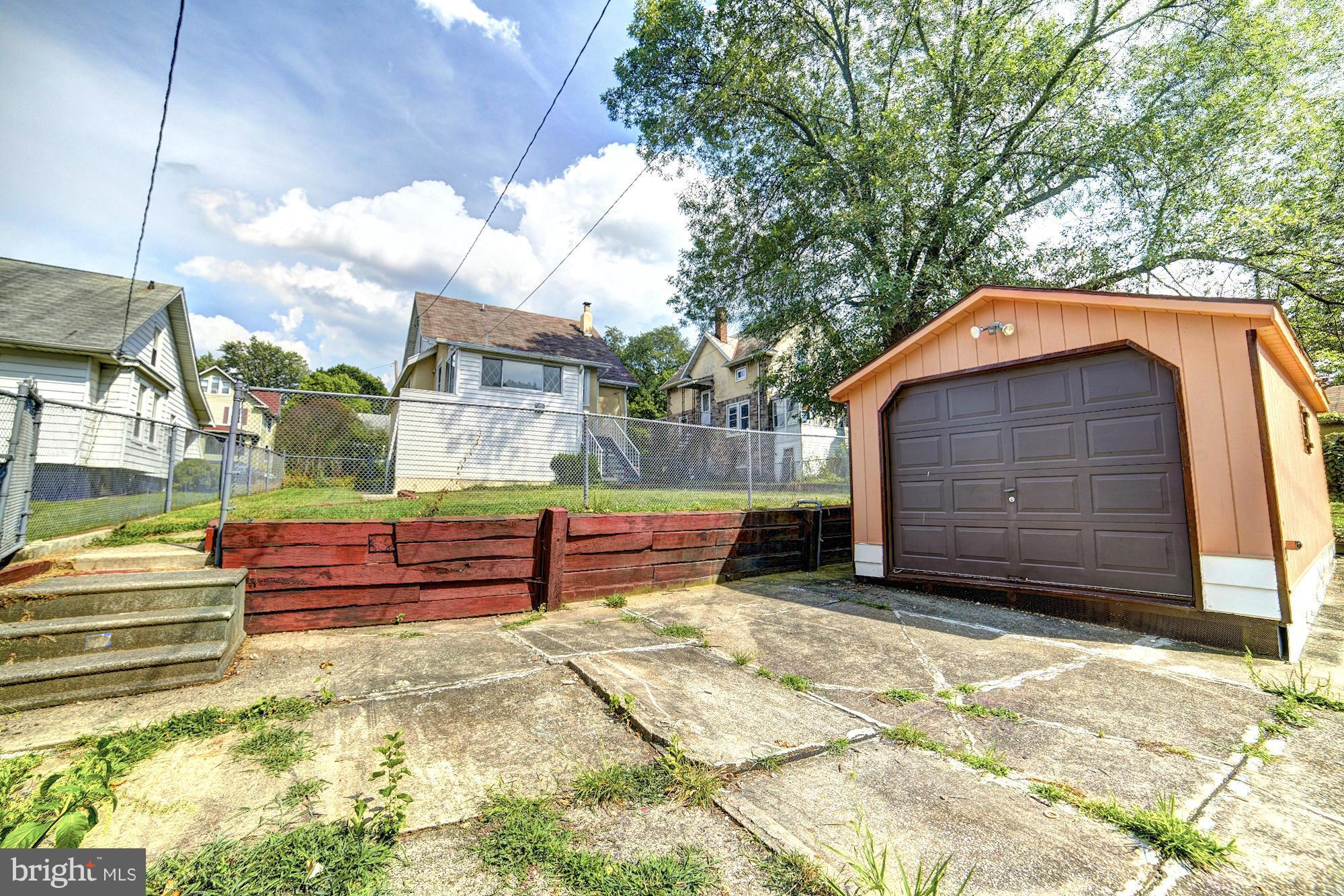 5408 Catalpha Road Baltimore, MD 21214 - Photo 23 of 23 a front view of a house with a yard