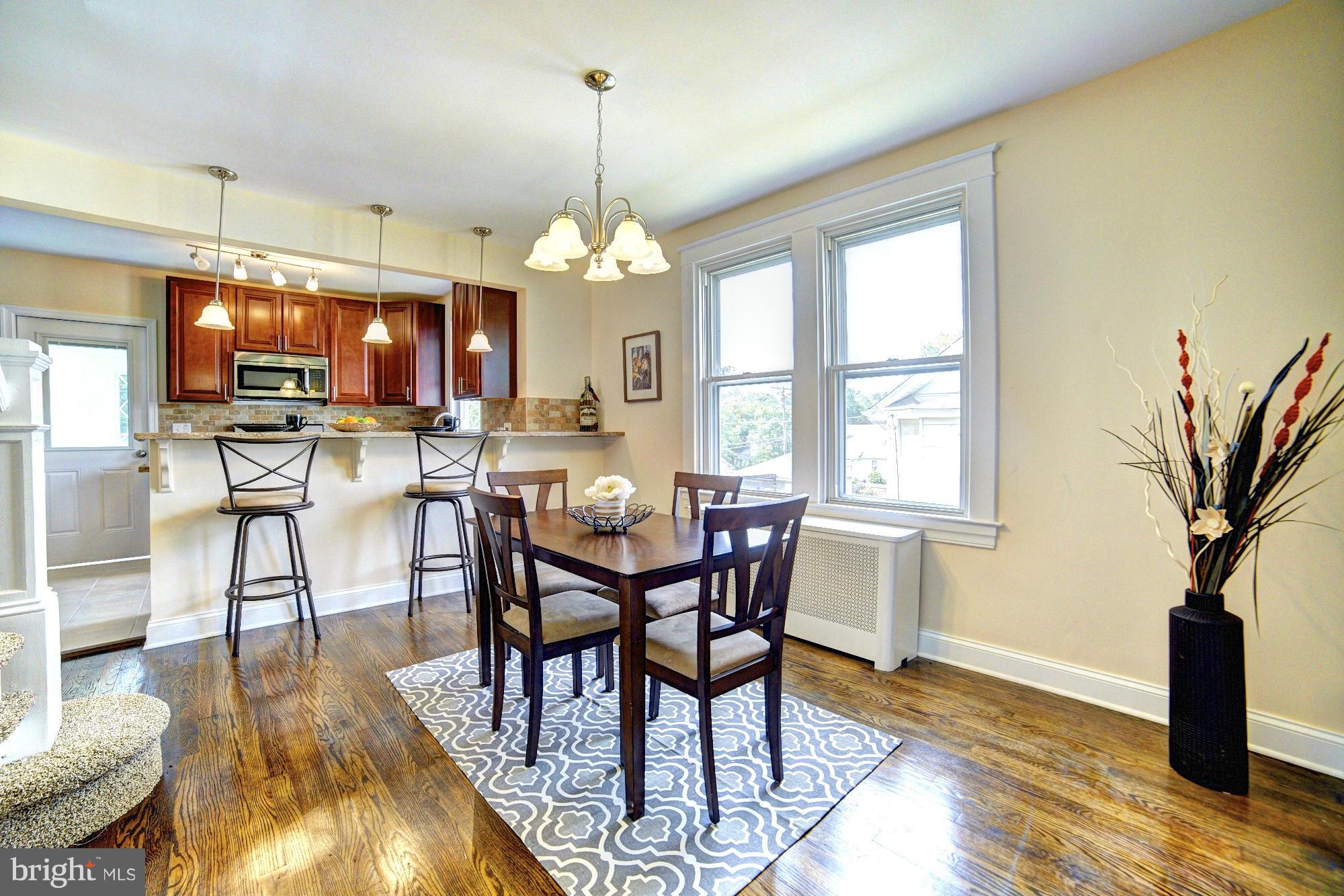 5408 Catalpha Road Baltimore, MD 21214 - Photo 5 of 23 a view of a dining room with furniture window and wooden floor