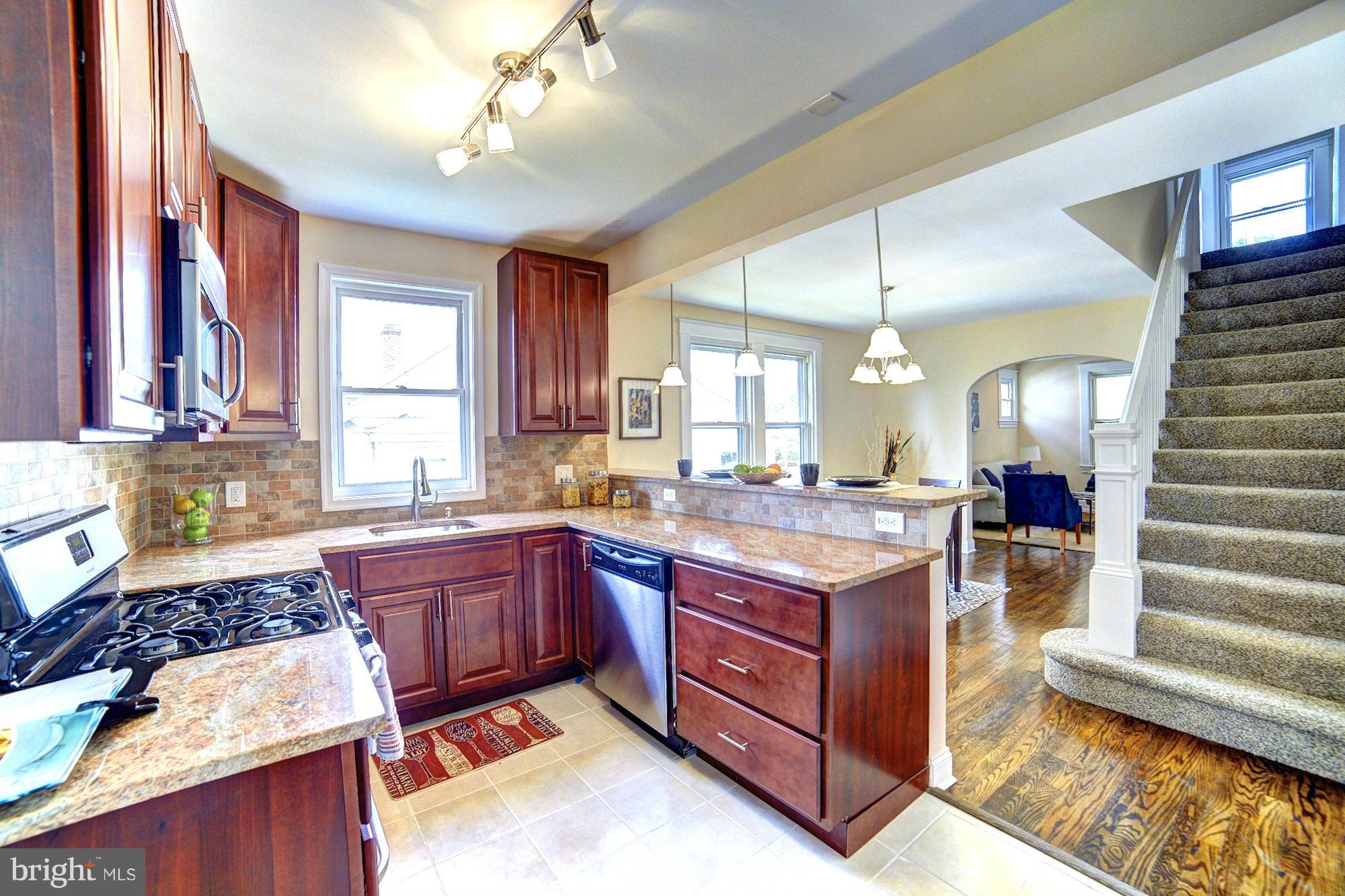 5408 Catalpha Road Baltimore, MD 21214 - Photo 7 of 23 a kitchen with a stove a sink and a refrigerator