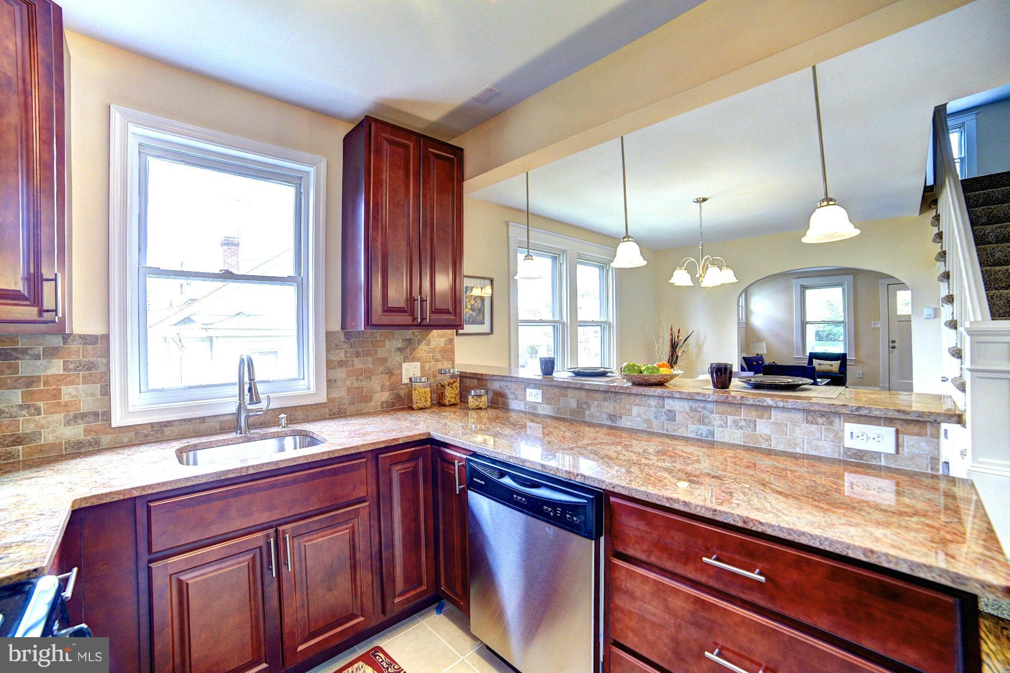 5408 Catalpha Road Baltimore, MD 21214 - Photo 9 of 23 a kitchen with lots of counter top space and a sink