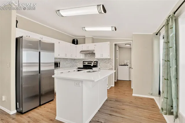 a kitchen with stainless steel appliances a refrigerator and a stove