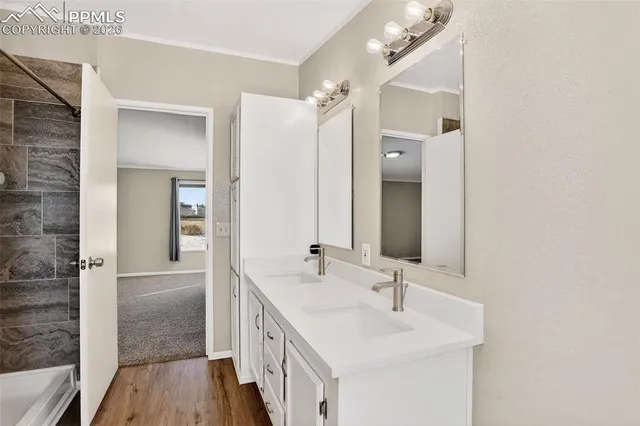 a bathroom with a double vanity sink and mirror