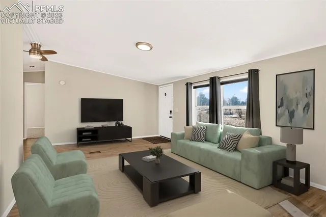 a living room with furniture and a flat screen tv