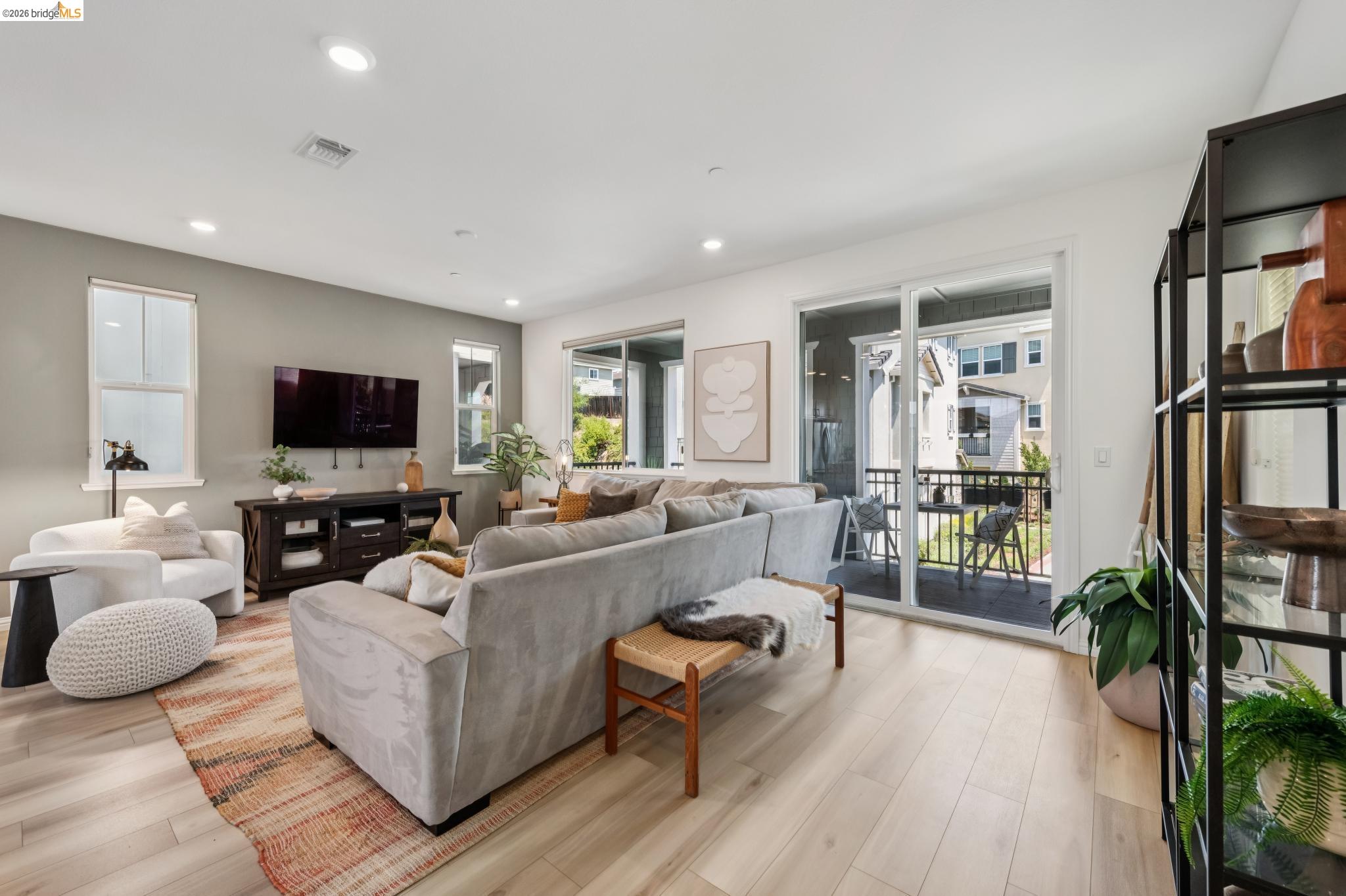 24157 Amaranth Loop Hayward, CA 94541 - Photo 15 of 63 Spacious living area featuring light wood-finish flooring and a neutral color palette
