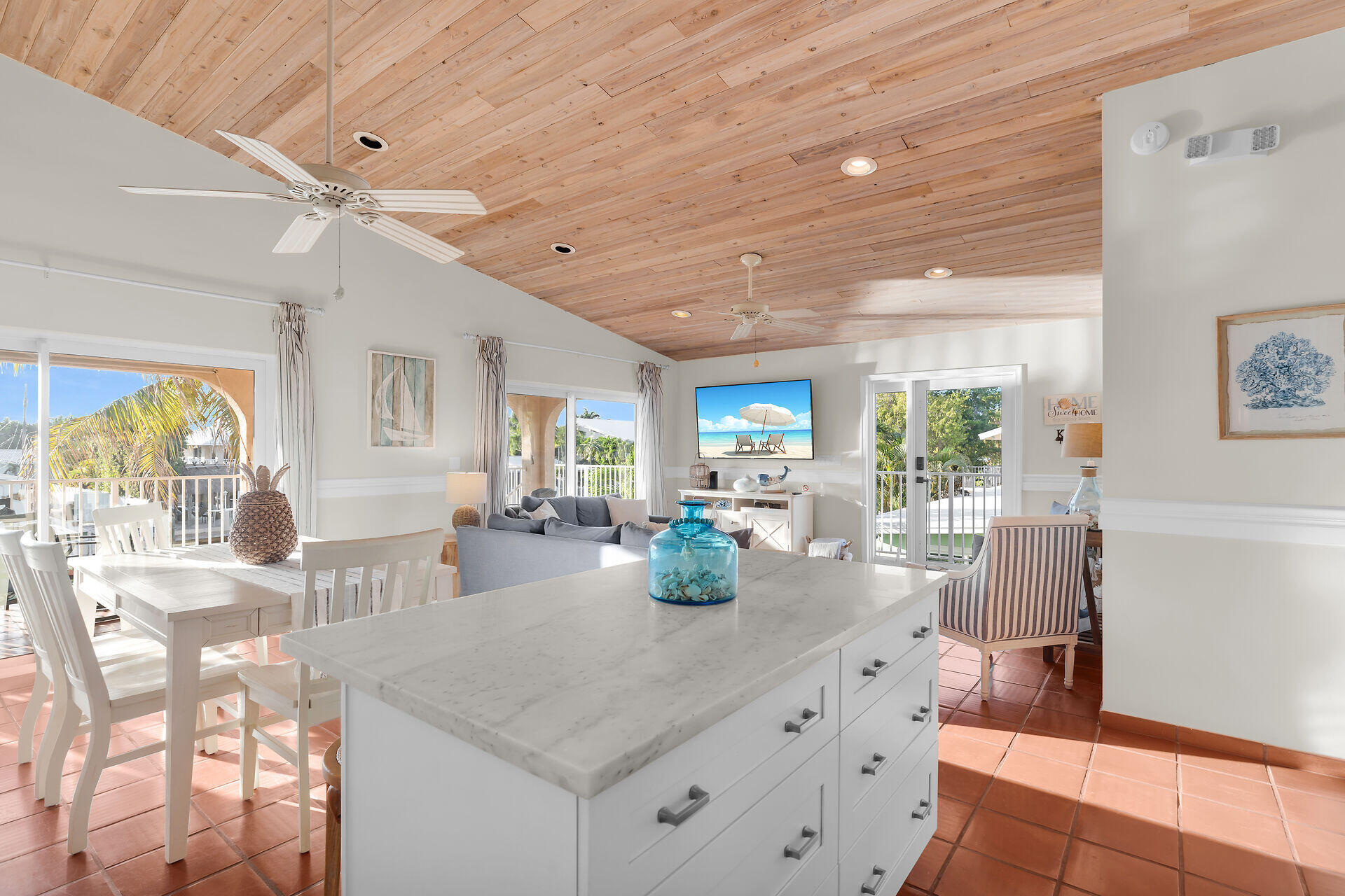 351 10th Street Key Colony Beach, FL 33051 - Photo 11 of 47 a kitchen with granite countertop a table and chairs in it