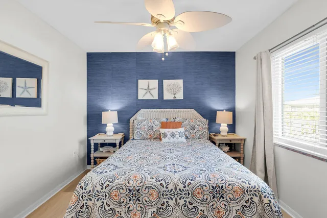 a bed sitting in a bedroom next to a window