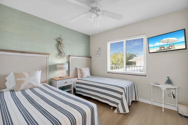 a bedroom with two beds and a table