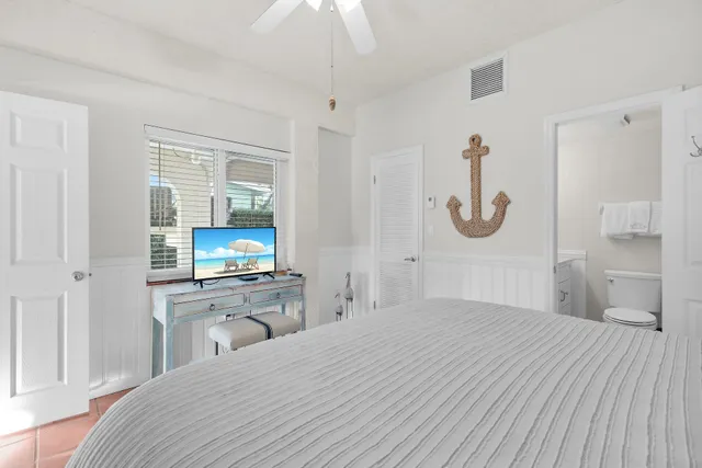 a bedroom with double bed and a chandelier