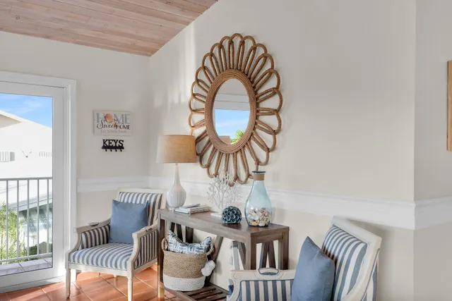 a view of a dining room with furniture a chandelier and wooden floor