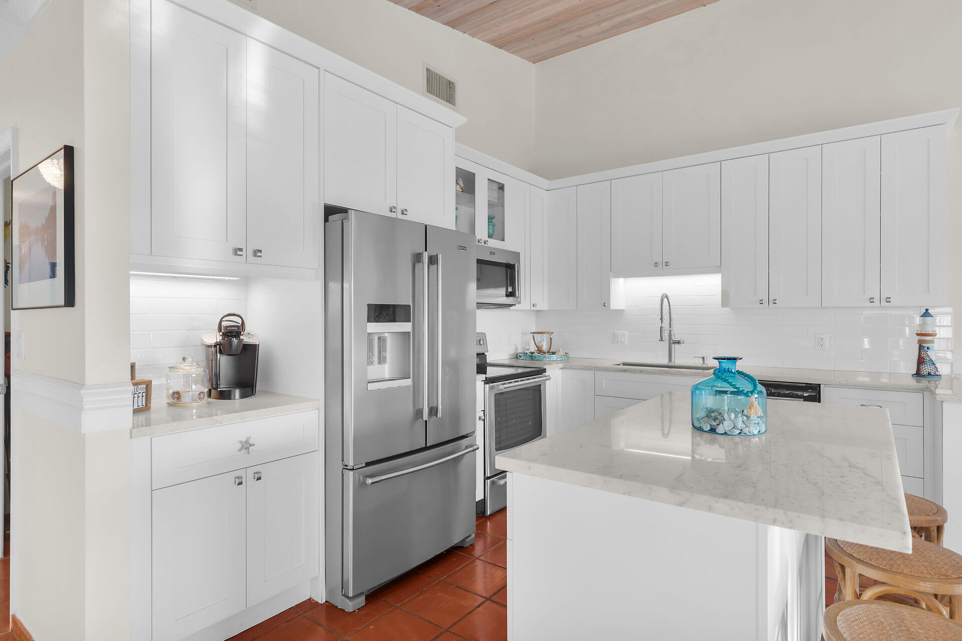351 10th Street Key Colony Beach, FL 33051 - Photo 10 of 47 a kitchen with stainless steel appliances a refrigerator sink and white cabinets