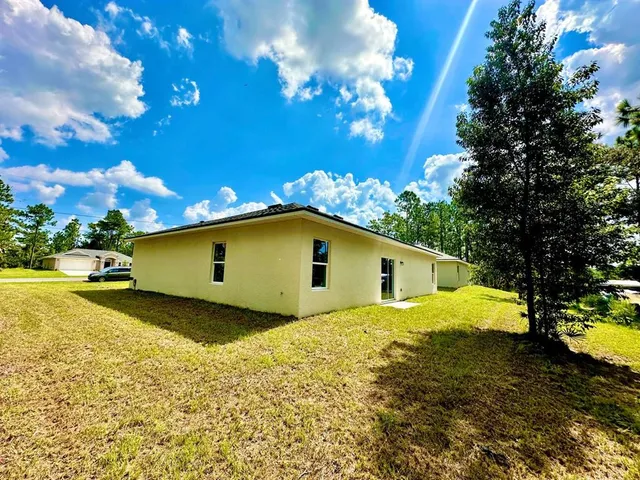 a yellow house with trees in front of it