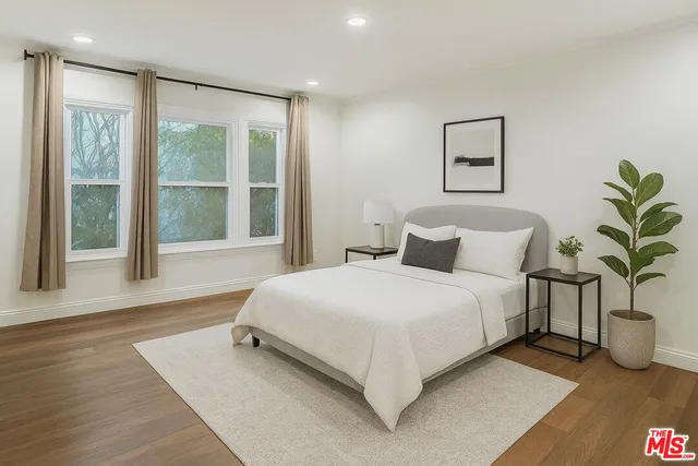 a bedroom with a large bed and a large window