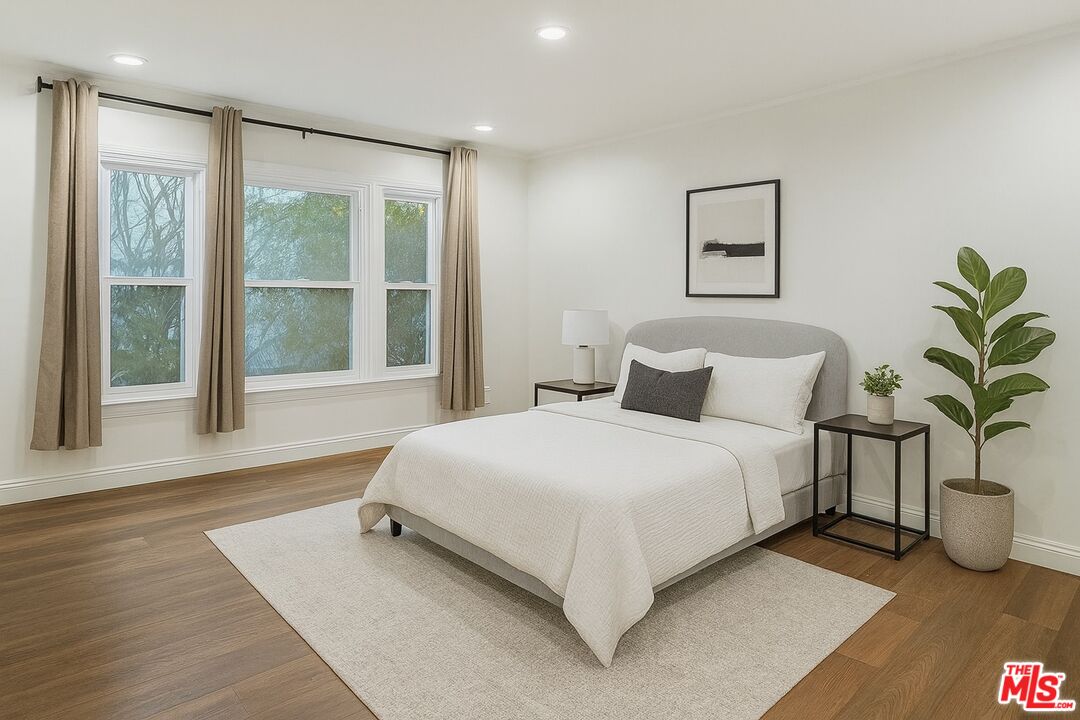 10517 Holman Avenue Los Angeles, CA 90024 - Photo 2 of 7 a bedroom with a large bed and a large window