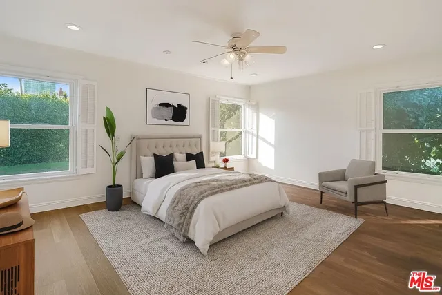 a spacious bedroom with a bed and a large window