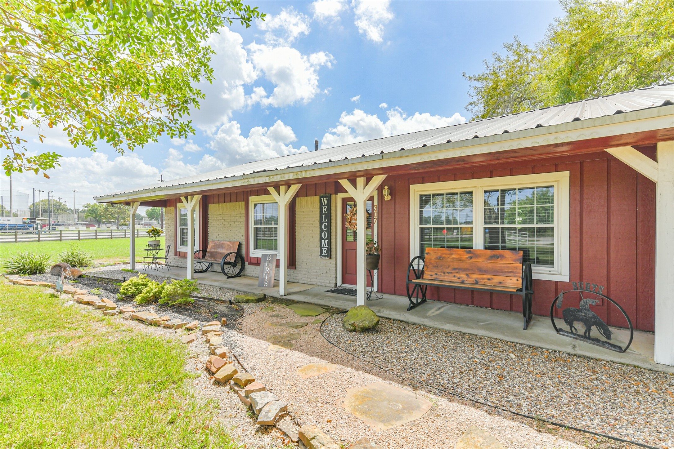 307 West Hufsmith Road Tomball, TX 77375 - Photo 1 of 44 Charming ranch-style home with a welcoming front porch, perfect for enjoying the scenic surroundings and country charm.