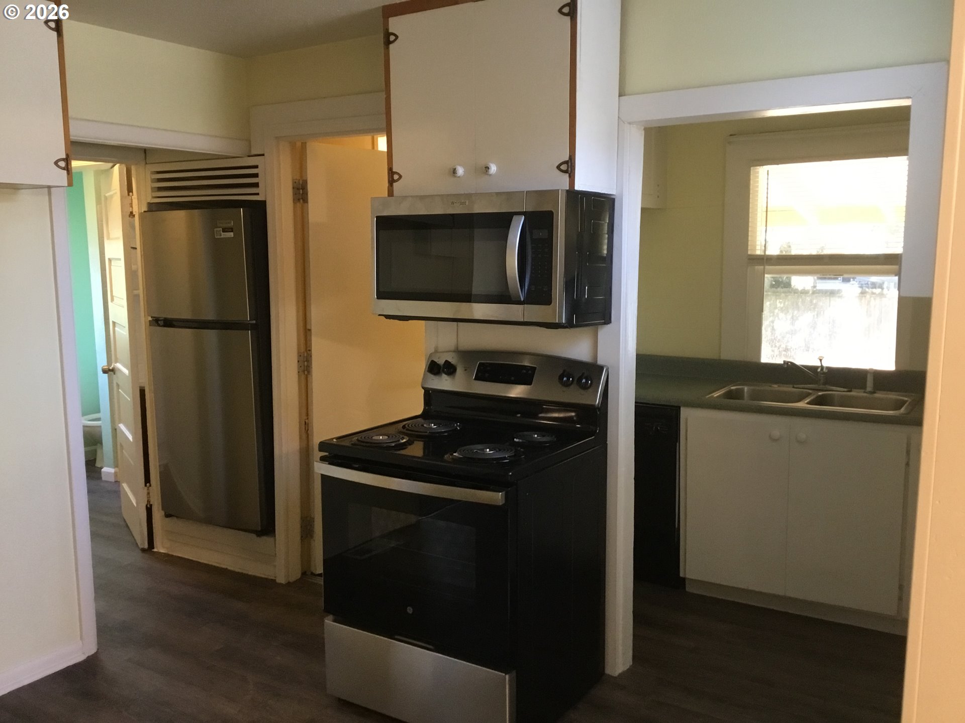 1224 Northeast 60th Avenue Portland, OR 97213 - Photo 2 of 14 a kitchen with a refrigerator stove and microwave