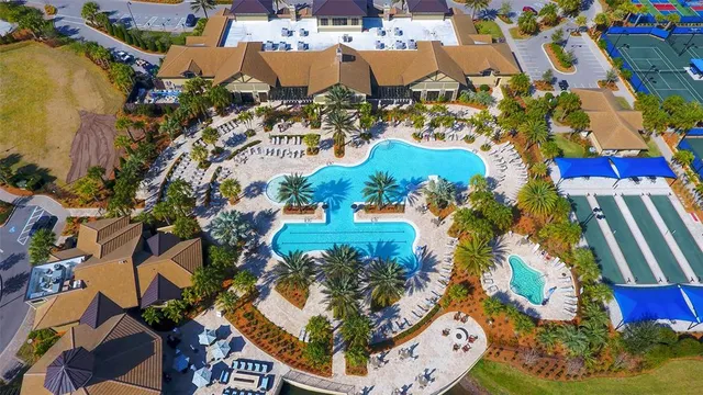 a view of a hallway with wooden floor and a living room