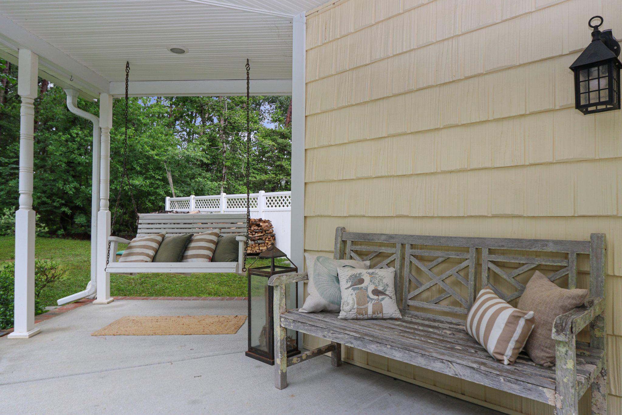 13431 Solitude Trail Machipongo, VA 23405 - Photo 9 of 32 Charming porch with swing and greenery.