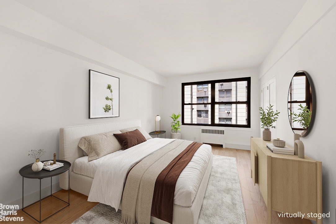 98-41 64th Road, Unit 3G Queens, NY 11374 - Photo 4 of 14 a bedroom with a bed a mirror and windows