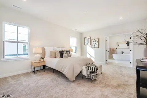 a spacious bedroom with a bed and a window