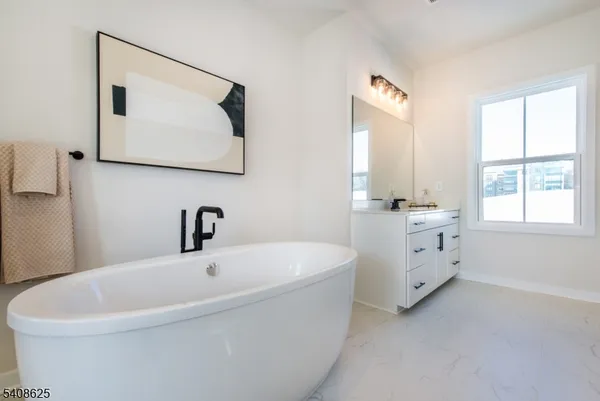 a white bath tub sitting next to a white sink