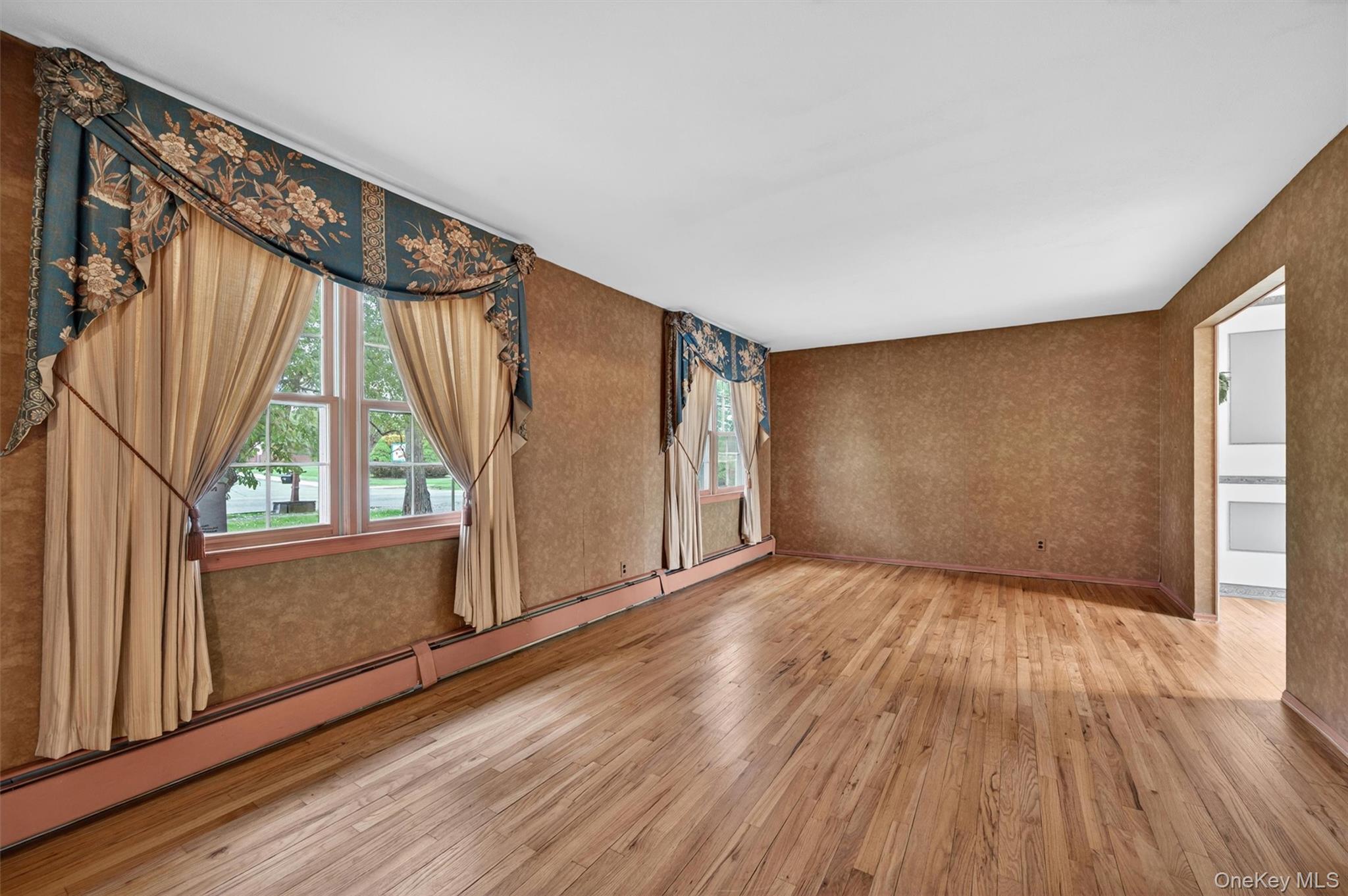 155 Pine Tree Road Monroe, NY 10950 - Photo 6 of 49 a view of an empty room with wooden floor and a window