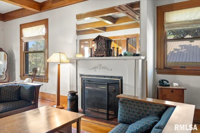 a living room with furniture fireplace and a large window