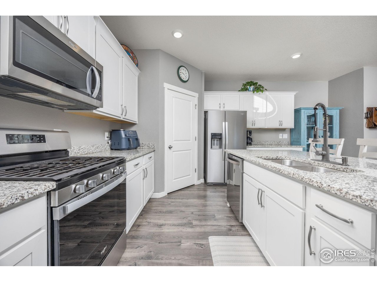 3725 Catmint Street Wellington, CO 80549 - Photo 19 of 44 Behind that door in the corner is a well-organized walk-in pantry, providing ample storage space for dry goods and staples, ensuring easy access and efficient organization within the home.