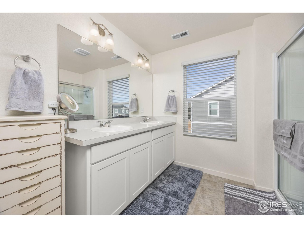 3725 Catmint Street Wellington, CO 80549 - Photo 25 of 44 Two sinks in the primary ensuite, offering convenience and space for morning routines.