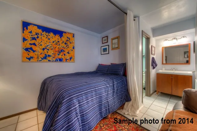 a bedroom with a bed and a view of bathroom