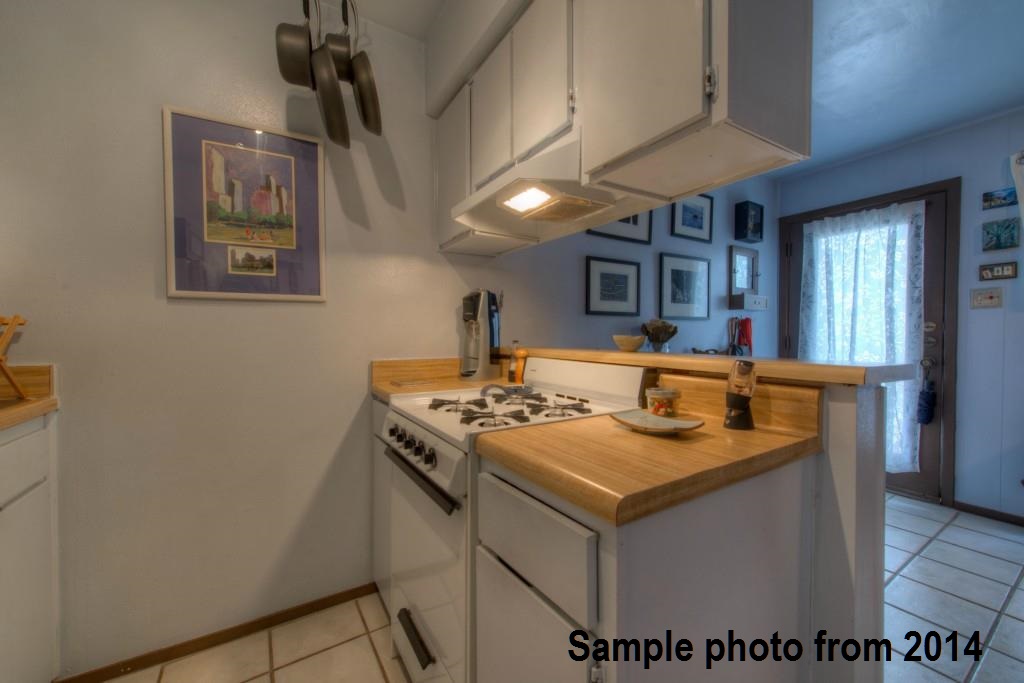 1111 West 10th Street, Unit 111 Austin, TX 78703 - Photo 10 of 25 a kitchen with a sink stove and cabinets