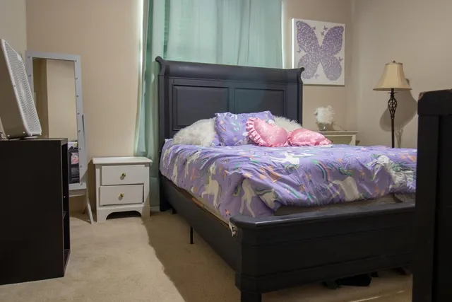 a bedroom with a bed and a window