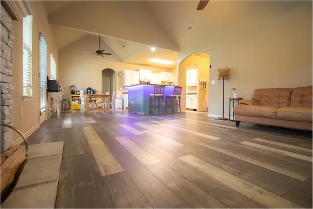 a living room with furniture and a chandelier