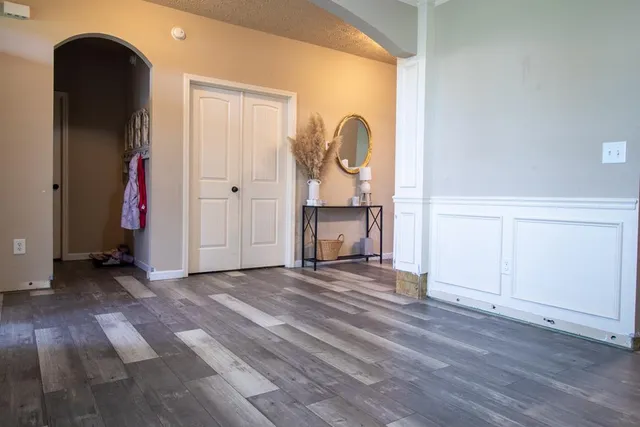 a view of empty room with wooden floor