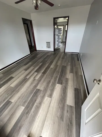 a view of an empty room and wooden floor
