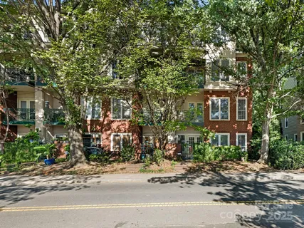 a city street lined with buildings and trees