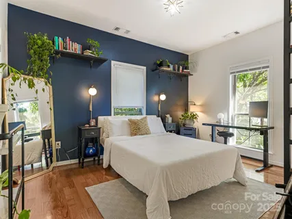 a bedroom with a bed window and a table