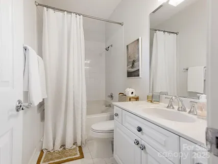 a bathroom with a double vanity sink mirror and toilet