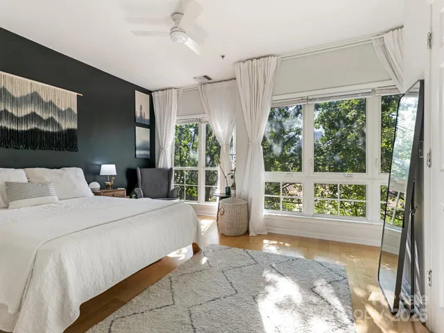 a bedroom with a large bed and a large window