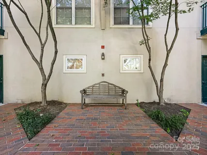 a view of a brick house with many windows