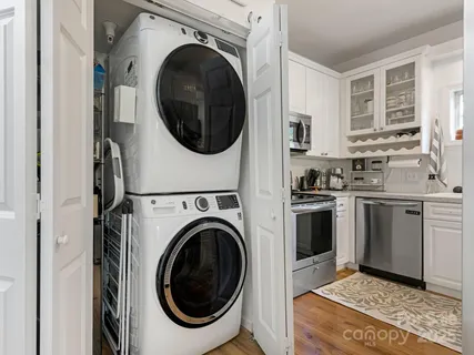 a kitchen with a washer and dryer in it