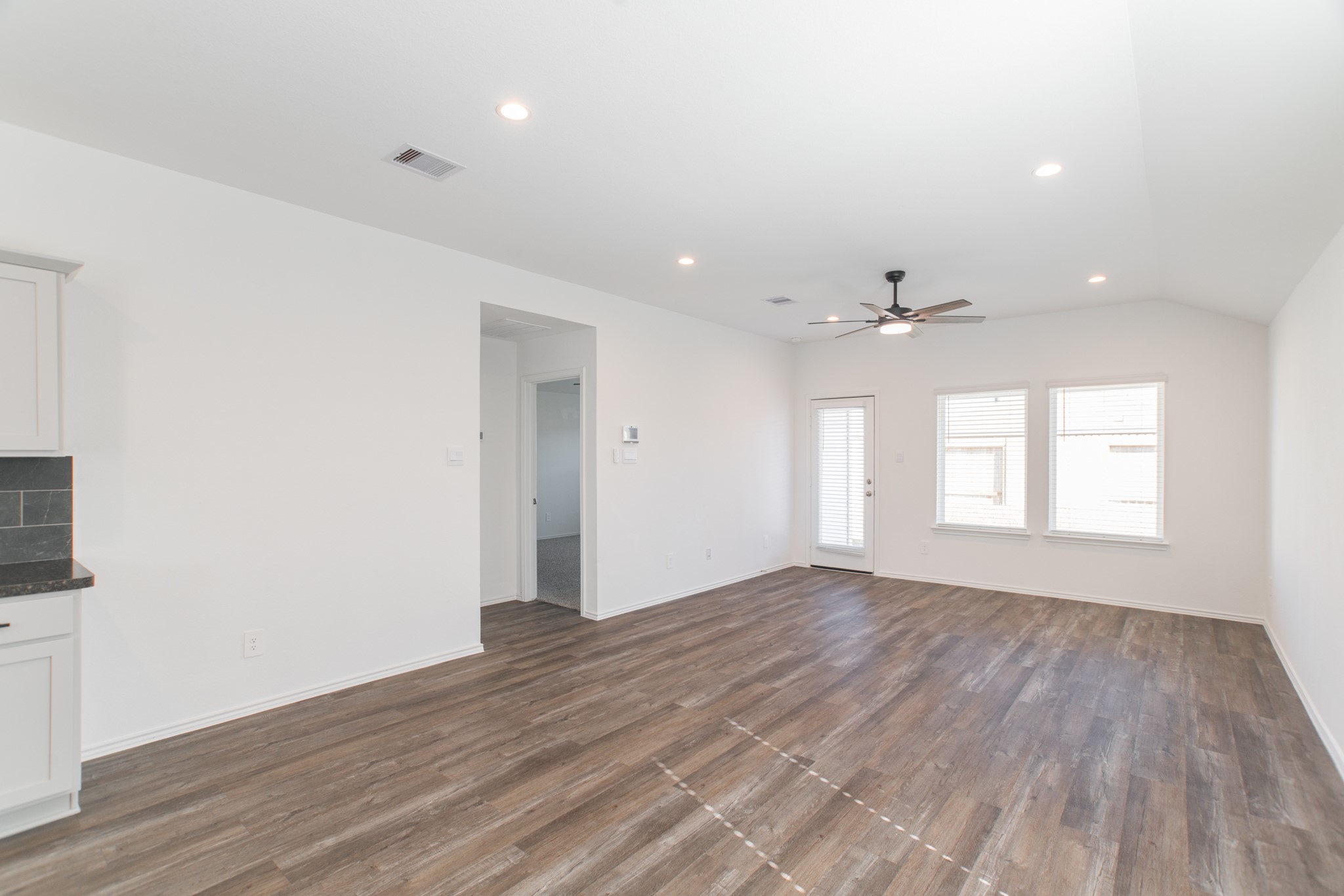 24314 Pebble Cres Lane Spring, TX 77373 - Photo 12 of 37 an empty room with wooden floor and windows