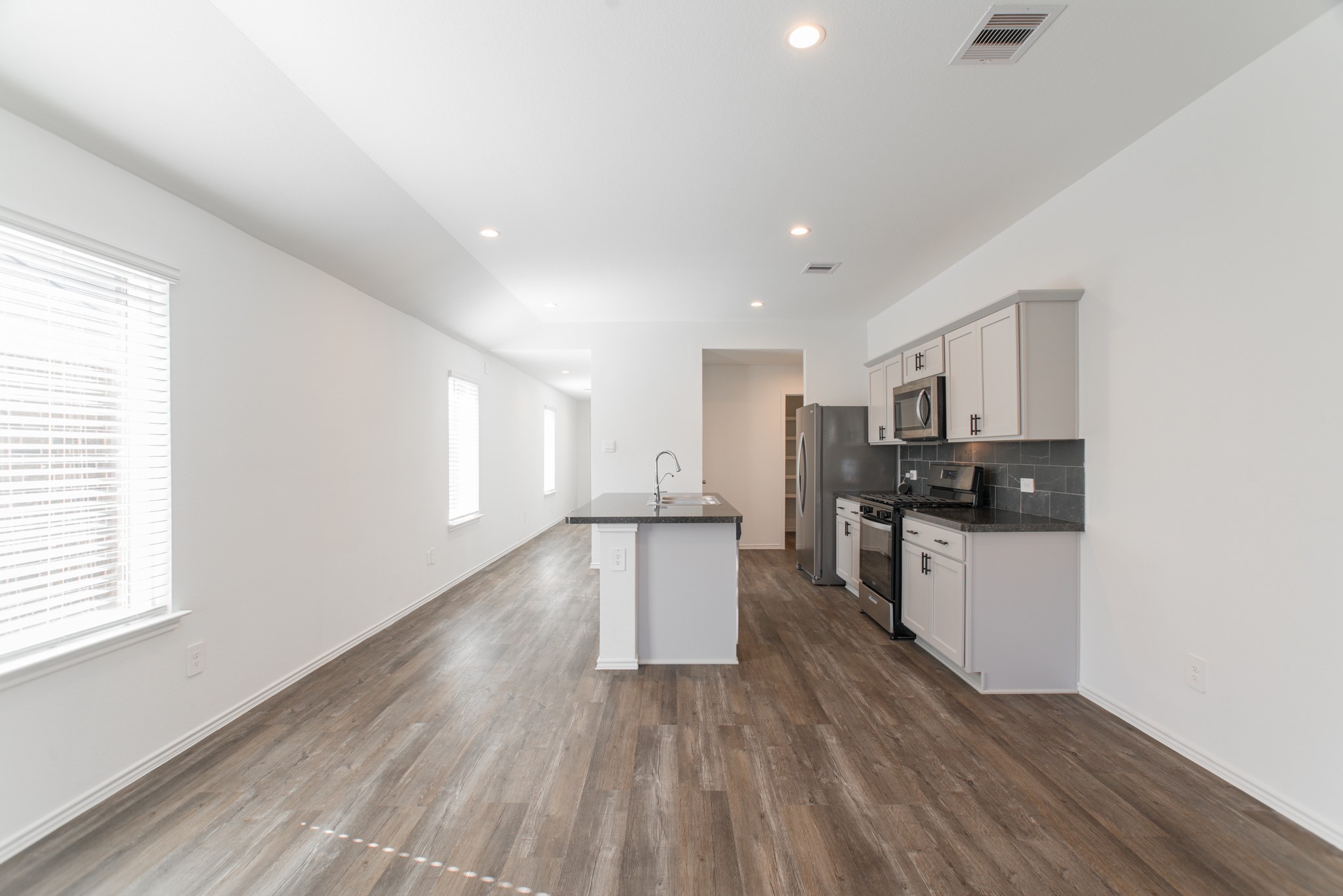 24314 Pebble Cres Lane Spring, TX 77373 - Photo 15 of 37 a kitchen with a refrigerator and a stove top oven
