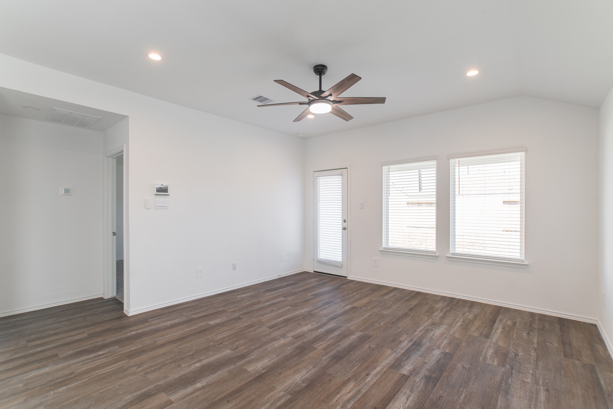 24314 Pebble Cres Lane Spring, TX 77373 - Photo 17 of 37 a view of an empty room with wooden floor and a window