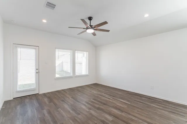 wooden floor in an empty room with a window