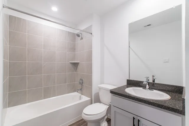 a bathroom with a sink a toilet and a mirror